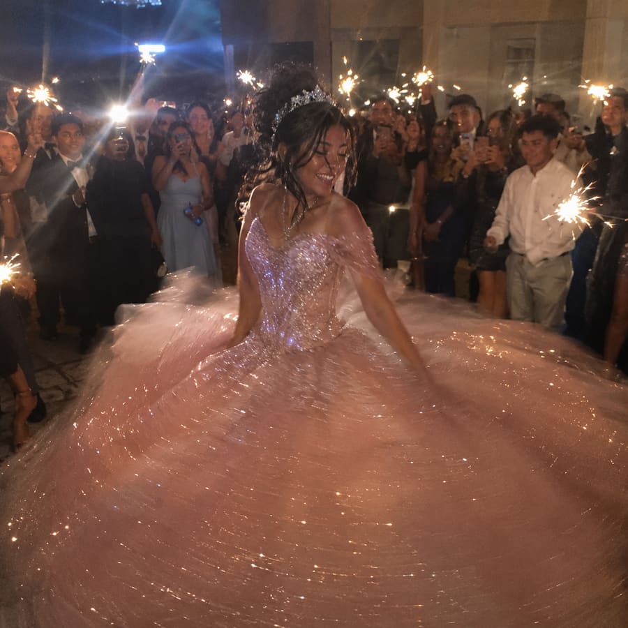 The event's cover photo: the quinceañera twirling in her dress
